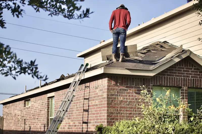 Professional roofer working on a residential roof in Castine